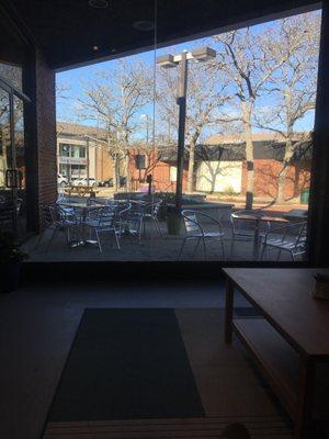 View of the outdoor seating from the couches inside.