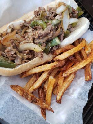 Philly beef cheesesteak with grill onions, bell peppers,and mayonnaise with hand cut fries.