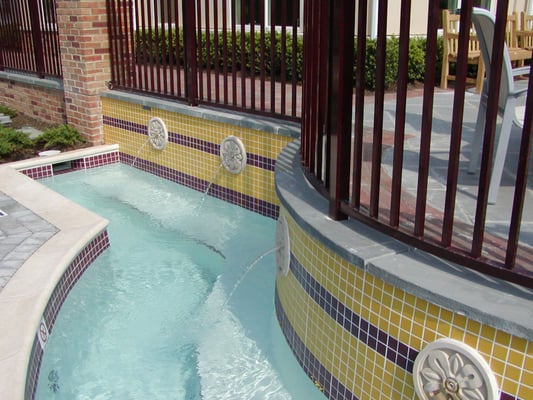 Designed & built by J & J Aquatics, this pool has beautiful custom water features.