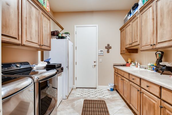 Nice size laundry with built-in cabinets. Appliances stay!