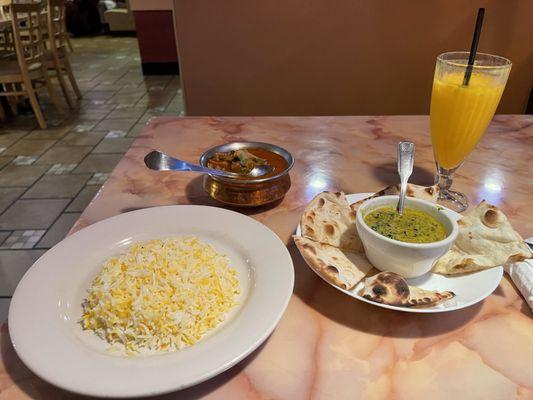 Curry goat, naan bread, basmati rice and a Mango Lassi.