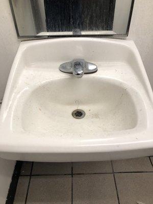 Sink has caked on dirt and hair no soap paper towels or hand dryer