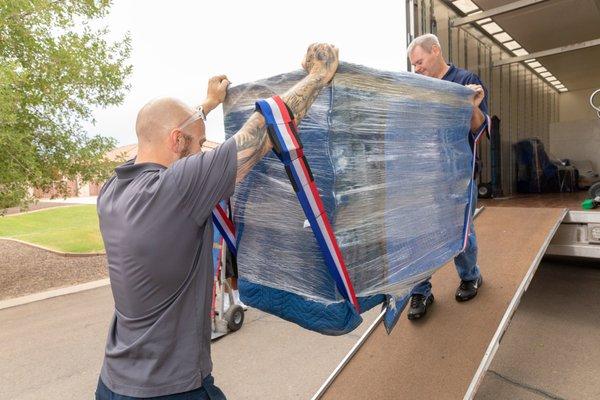 Carefully lifting items into our truck for a safe transport!!!