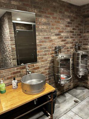 The coolest bathroom motif... beer kegs for urinals  and sinks