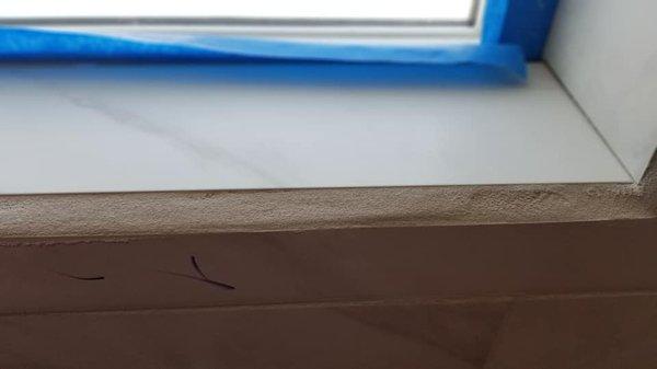 Grout around window, rough and uneven