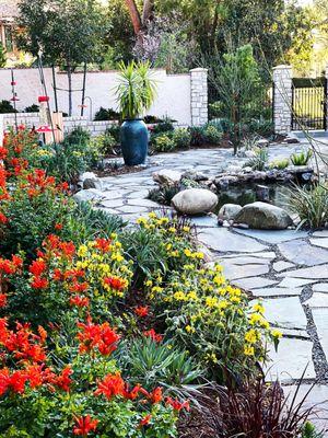 A gorgeous new flagstone patio, and a lovely koi pond, surrounded by a lush drought tolerant garden.