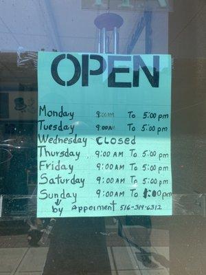 Hours of operation posted on front door.