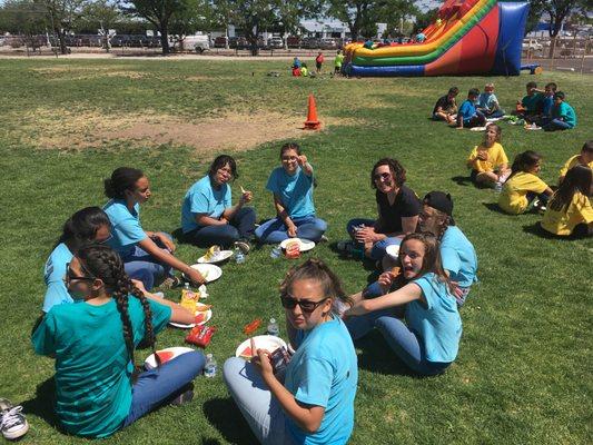 OLA students & the principal enjoying lunch on field day 2018.