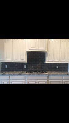 Glass backsplash with granite counters.