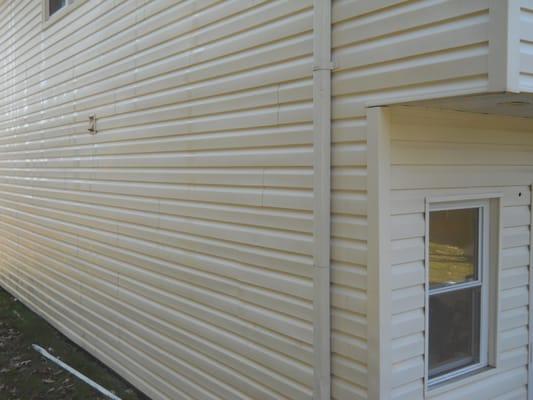 Siding was treated with a solution to remove mold and mildew, then power washed.