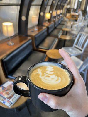 Vanilla latte with some seriously skilled swan latte art