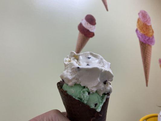 Double scoop mint chocolate chip over chocolate chip cookie dough on a chocolate dipped waffle cone