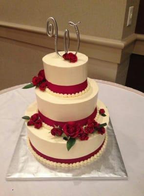 Gorgeous three tier wedding cake with rose accents.