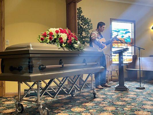 The lovely casket and floral arrangement that Laura helped us choose for our loved one.