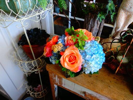 Summery Mix- Blue Hydrangeas, Orange Roses, Scented Geranium Leaves