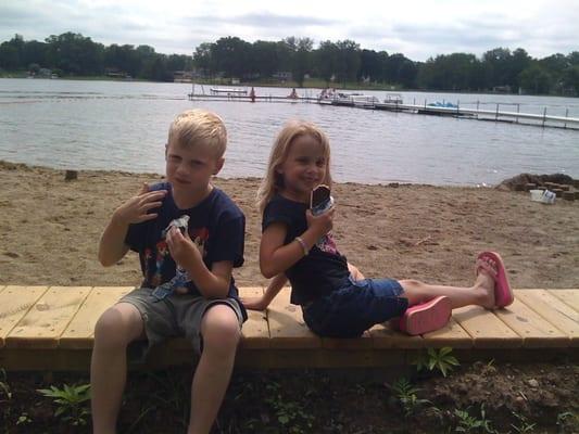 My kids eating ice cream on the lake front.