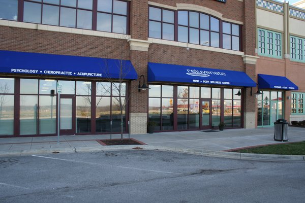 Under the big blue awning next to US Bank