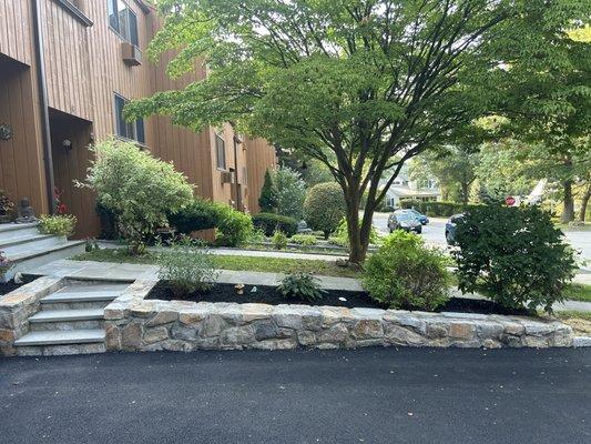 Side stoop and stone wall rebuilt