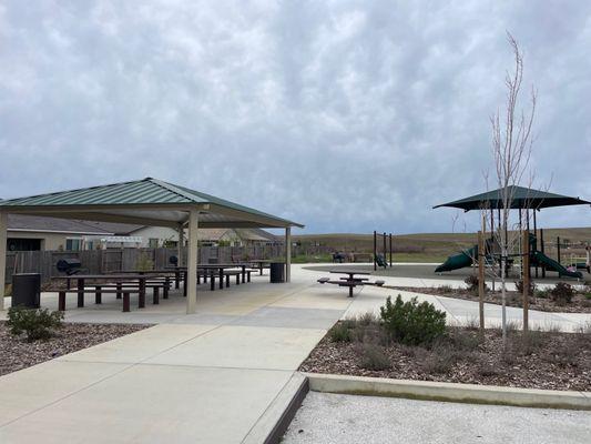 Grills and tables are next to the playground