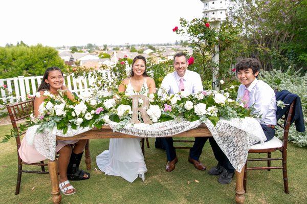 My husband, our kids, and me at our head table. Beautiful photo captured by Jazley