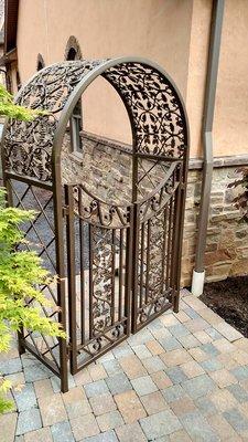 Custom made wrought iron Arbor with iron gates in Williamsport, PA  to match existing metal railings, trellises and pergola. Made by www.vil