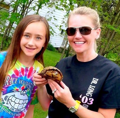 Sporting our Tin Fin shirts, saving an endangered turtle from the road and a happy patient after her appointment.