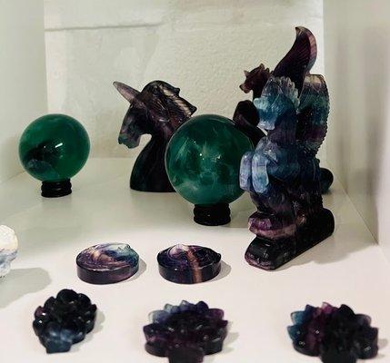 Rainbow fluorite Pegasus, Nine-Tailed Fox, anf moon carvings with green fluorite spheres.