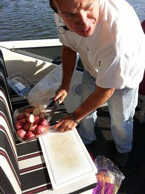 Bob, a member of the crew, cut up veggies, to throw to the pigs.