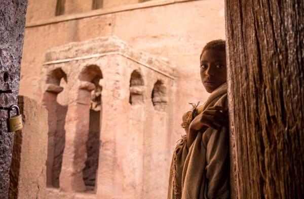 A boy peers into the camera in Lalibela, Ethiopia