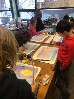 Students dive into the magical world of wet on wet watercolor, letting the colors blend and flow, creating breathtaking works of art.