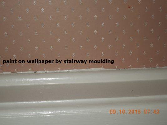 More sloppy painting of moulding.  Damaged wallpaper.