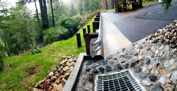 More drainage and retaining wall buried shoring up end of driveway