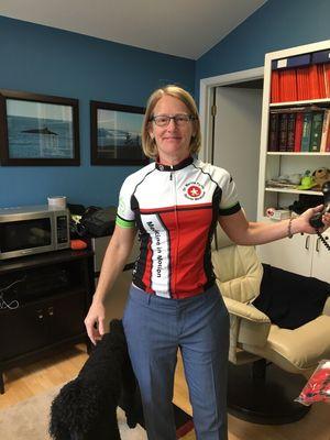 Dr Pyron sporting the new Medicine in Motion team cycling jersey in her office.