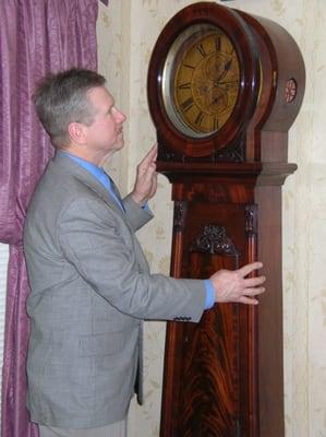 Mr. Kasnak inspecting a 19th Century Tall Case Clock for Appraisal Value