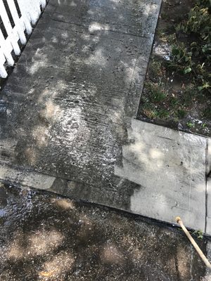 Power washing sidewalk