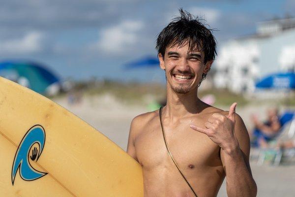 OIB Kahuna surfer throwing the shaka