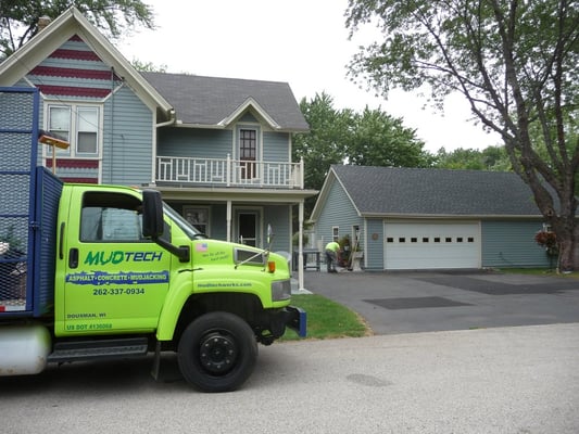 MUDTeCH is repairing pavement, and adding curb to this property.