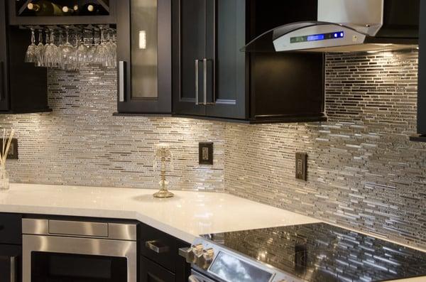 Tile backsplash accent the walls of the beautifully remodeled kitchen by KabCo Kitchens