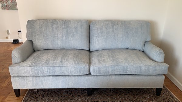 I don't think my cell phone does the color well. Couch is on legs and makes it look less bulky for our DC condo.