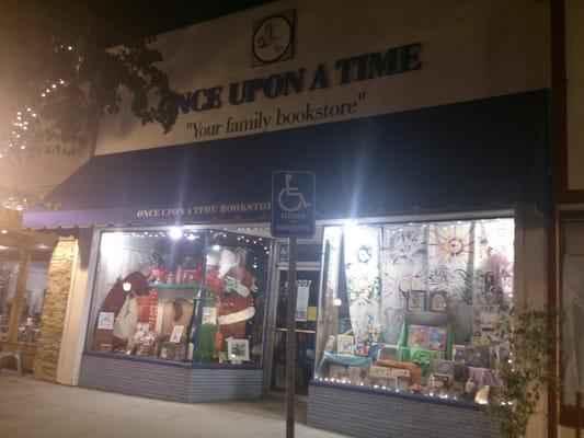 Night scene: Santa visits in the  store front window to the left.  2013-11-29