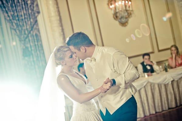 Groom and bride happily share their first dance.