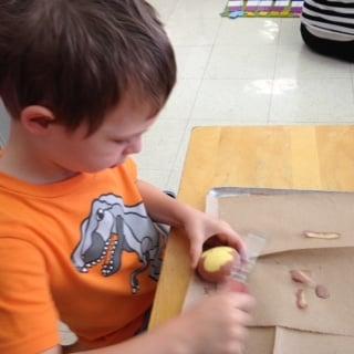 Preschool students participate in practical life exercises like peeling vegetables.