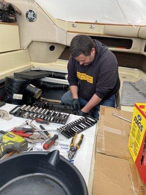 Tearing down an engine inside the boat is a difficult job.