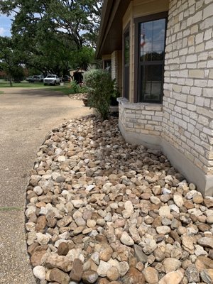 In this project we removed existing rock added fabric and put the river rock back in flower bed