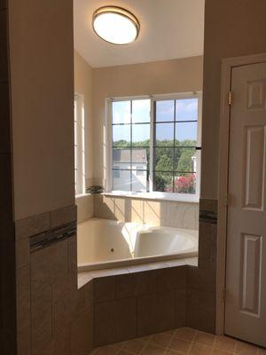 A new light was installed above the jacuzzi tub. Insulation was added around the jacuzzi & new tile.