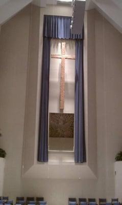 Great old rugged cross hanging from the front of the sanctuary.