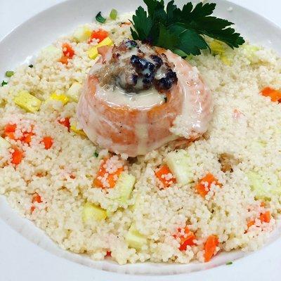 Salmon filet, finished in a maple cream almond sauce served over a bed of vegetable couscous