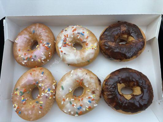 The donuts on the left side are supposed to be strawberry frosted donuts with sprinkles. All the donuts were wet and smeared.