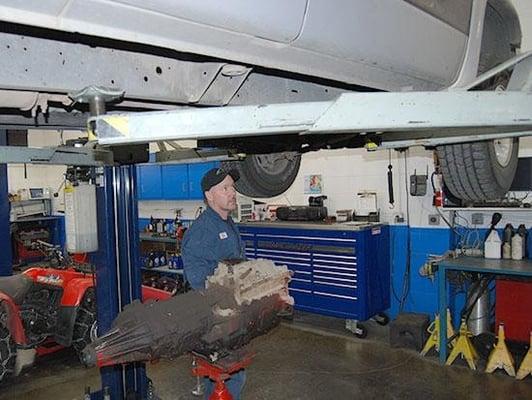 Tom from Brandy's Automotive working under a clients car.