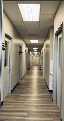 Our main hallway, featuring exam rooms, a diagnostic testing room, lasers, an optometry workshop, and nurse station.